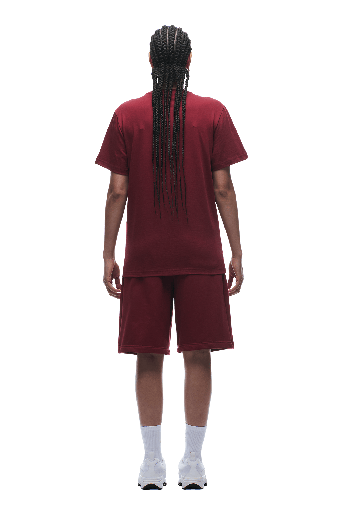 A person with long braids wears the 6PM T-SHIRT REGULAR FIT WINE RED and matching shorts, paired with white socks and sneakers, standing on a plain background—effortlessly flexing a classic look.