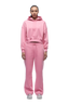 A person faces forward in a 6PM WMNS CROPPED HOODIE BUBBLEGLOW set and white sneakers, against a plain white background.