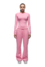 A person faces forward in a 6PM WMNS LONGSLEEVE BUBBLEGLOW top and matching pants with a drawstring, paired with white sneakers against a plain white background.