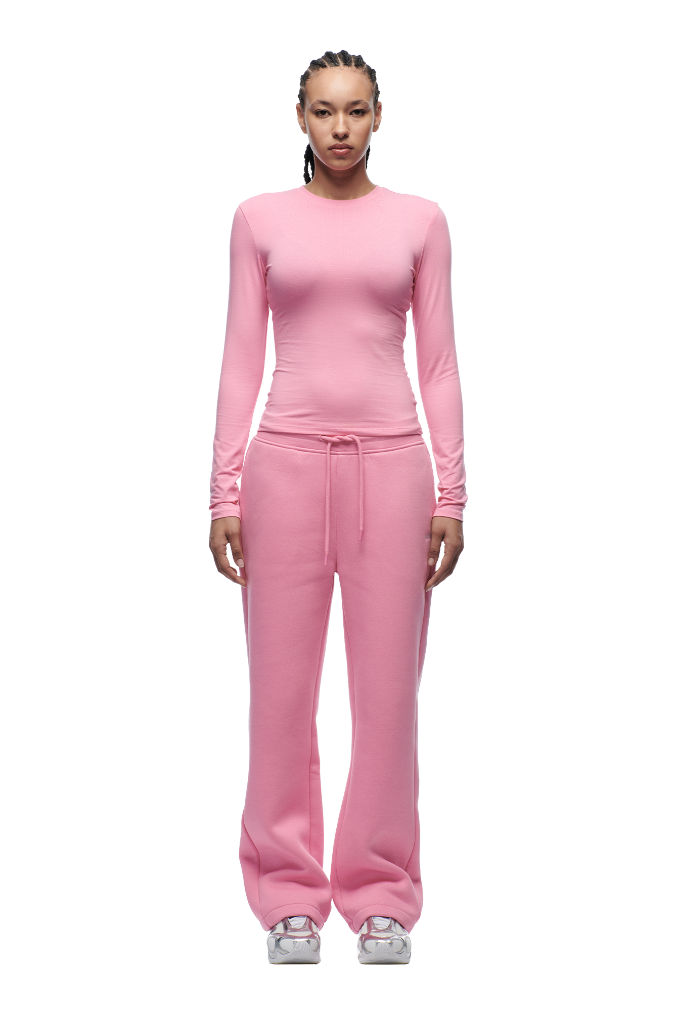 A person faces forward in a 6PM WMNS LONGSLEEVE BUBBLEGLOW top and matching pants with a drawstring, paired with white sneakers against a plain white background.