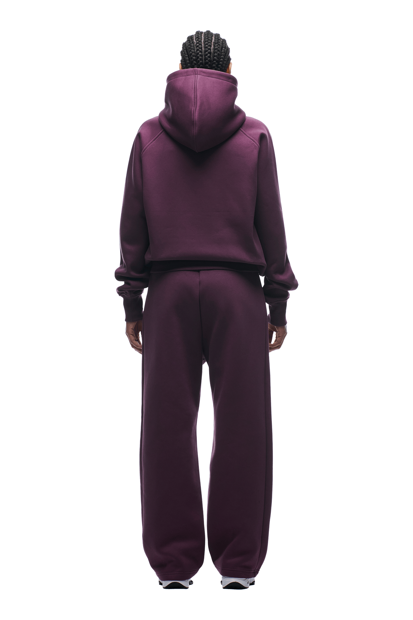 Person with braided hair, seen from behind, wears the 6PM HOODIE PLUM with raglan sleeves and kangaroo pocket, plus matching sweatpants, standing against a plain background. Perfect for everyday wear.