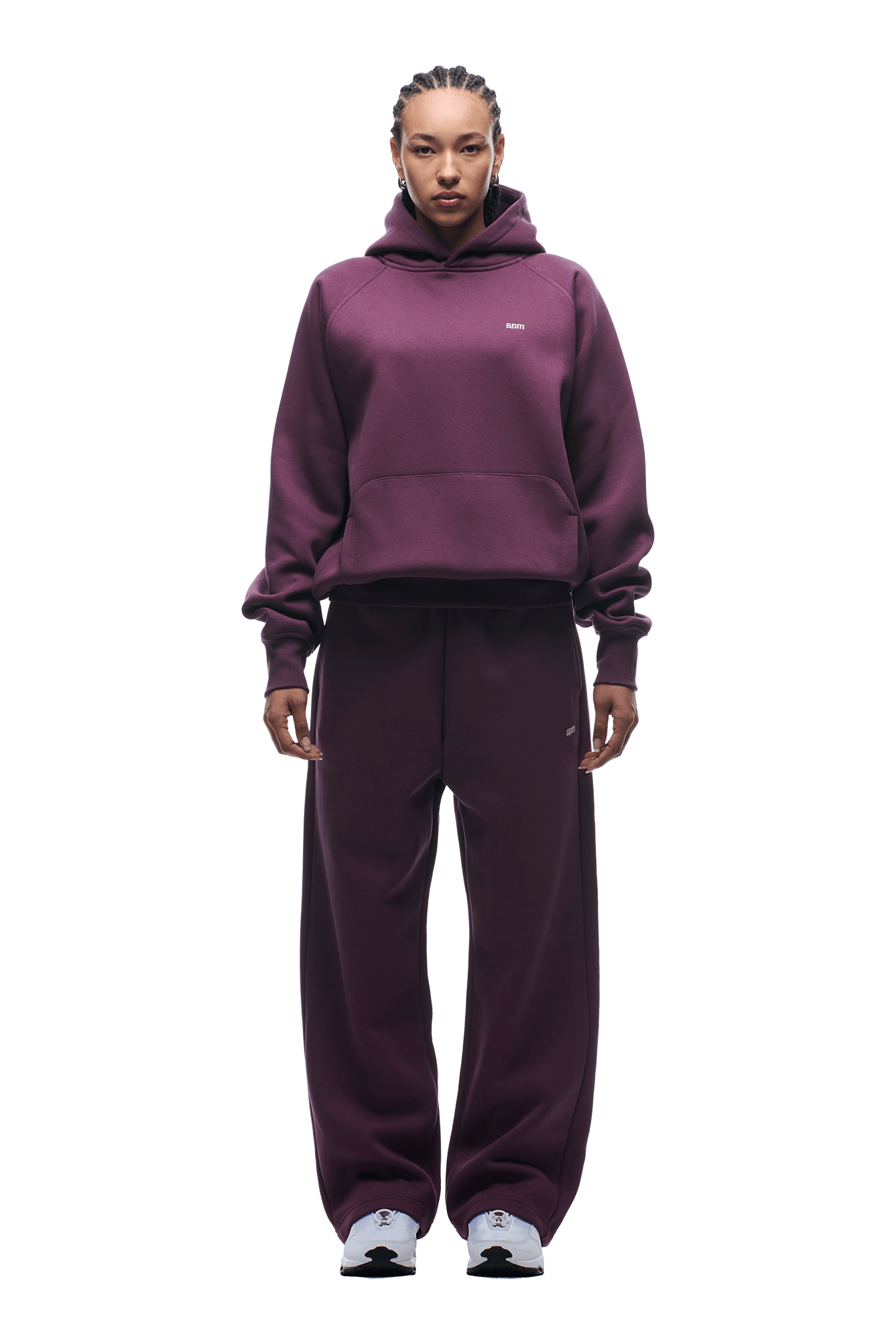 A person stands facing forward in a 6PM HOODIE PLUM raglan sleeve hoodie with kangaroo pocket and matching sweatpants, paired with white sneakers. The background is transparent.