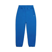 The 6PM CUFF JOGGER PRINCESS BLUE features a classic sweatpants fit with an elastic waistband and cuffs, two side pockets, and a small white logo on the left hip, shown on a plain white background.
