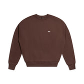 The 6PM CREWNECK CHOCOLATE BROWN sweatshirt features long sleeves, ribbed trims, and a small white logo on the left chest, shown on a white background.