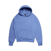 The 6PM HOODIE PERSIAN BLUE features light blue raglan sleeves, a front kangaroo pocket, and a small white chest logo—perfect for everyday wear. Shown on a plain white background.