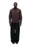 A man stands facing forward, wearing the 6PM HOODED DRESS SHIRT in blue, orange, and black, paired with wide-leg black pants and black shoes against a plain white background.