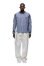 A man faces forward wearing the 6PM HOODED DRESS SHIRT DEEP SEA BLUE/WHITE, paired with white wide-leg pants and white sneakers, set against a plain light background.