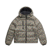 The 6PM PUFFER JACKET MINI CAMO is a hooded puffer with a multicolored camo print, front zipper, zippered chest pocket, and side pockets, shown on a white background.