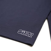 A midnight blue GRAFFITI RINGER LS T-shirt by 6PM featuring "SiXPM" in white bubble letters near the bottom hem.