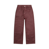 The 6PM WAX COATED DENIM DARK BURGUNDY are high-waisted, wide-leg pants with front and back pockets, belt loops, and a button-zip closure, shown in rich maroon on a white background.