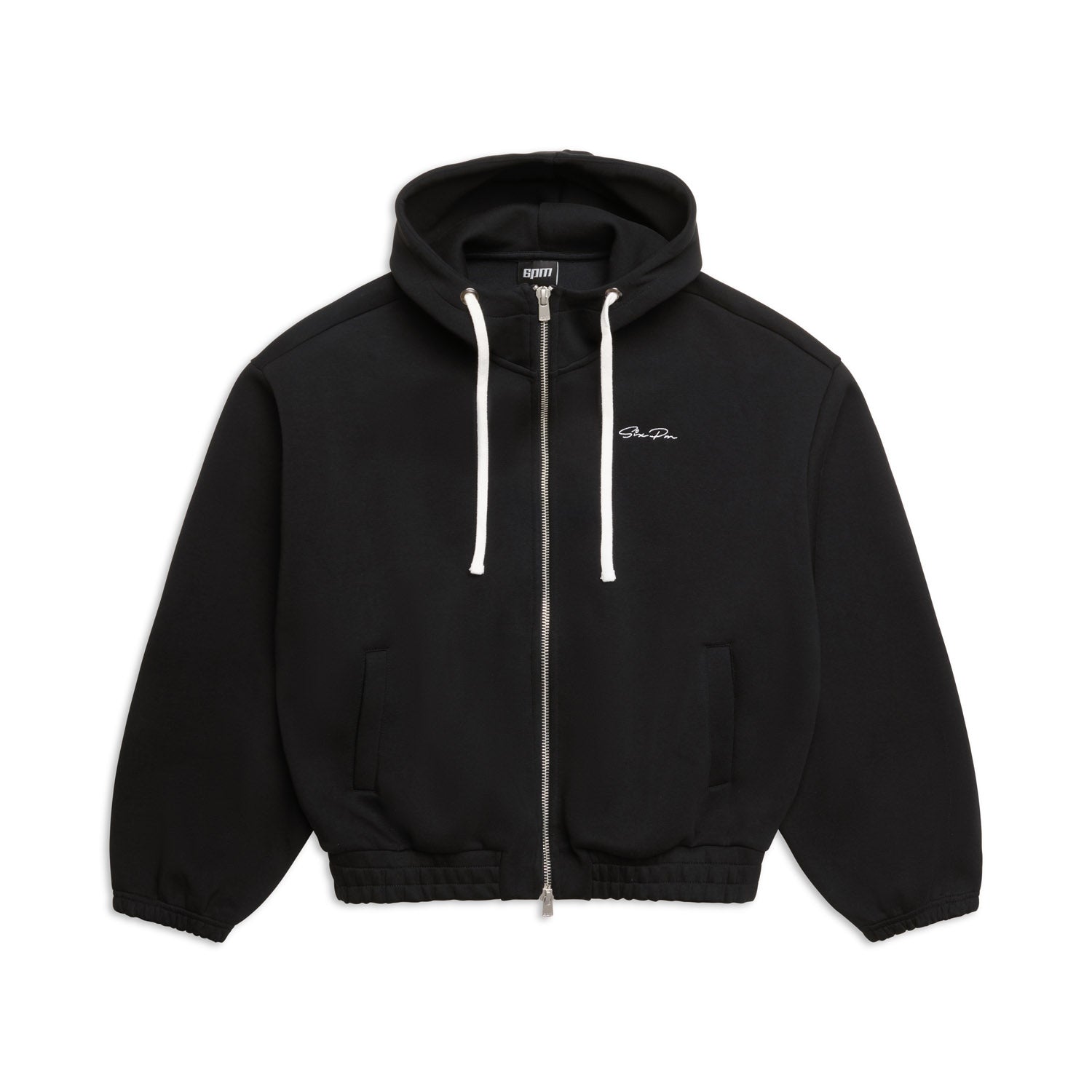 The 6PM BOXY ZIP HOODIE BLACK features white drawstrings, ribbed cuffs and hem, and small white text on the left chest. It is displayed laid flat on a white background.