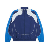 The 6PM EVERYDAY TRACK JACKET SHADOW BLUE is a blue and white track jacket with a front zipper, long sleeves, elastic cuffs and hem, curved white accents, and light blue panels on the shoulders and arms.
