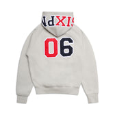 The COLLEGE LETTER HOODIE SMOKE GREY by 6PM is a light gray hoodie shown from the back, featuring bold red and black “06” numbers and vibrant SIXND text along the edge of the hood.