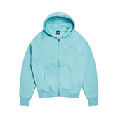 The 6PM ZIP HOODIE TURQUOISE features a light blue hue, hood, zip-up front, front pockets, and ribbed cuffs and hem for a structured feel and clean finish, shown laid flat on a white background.