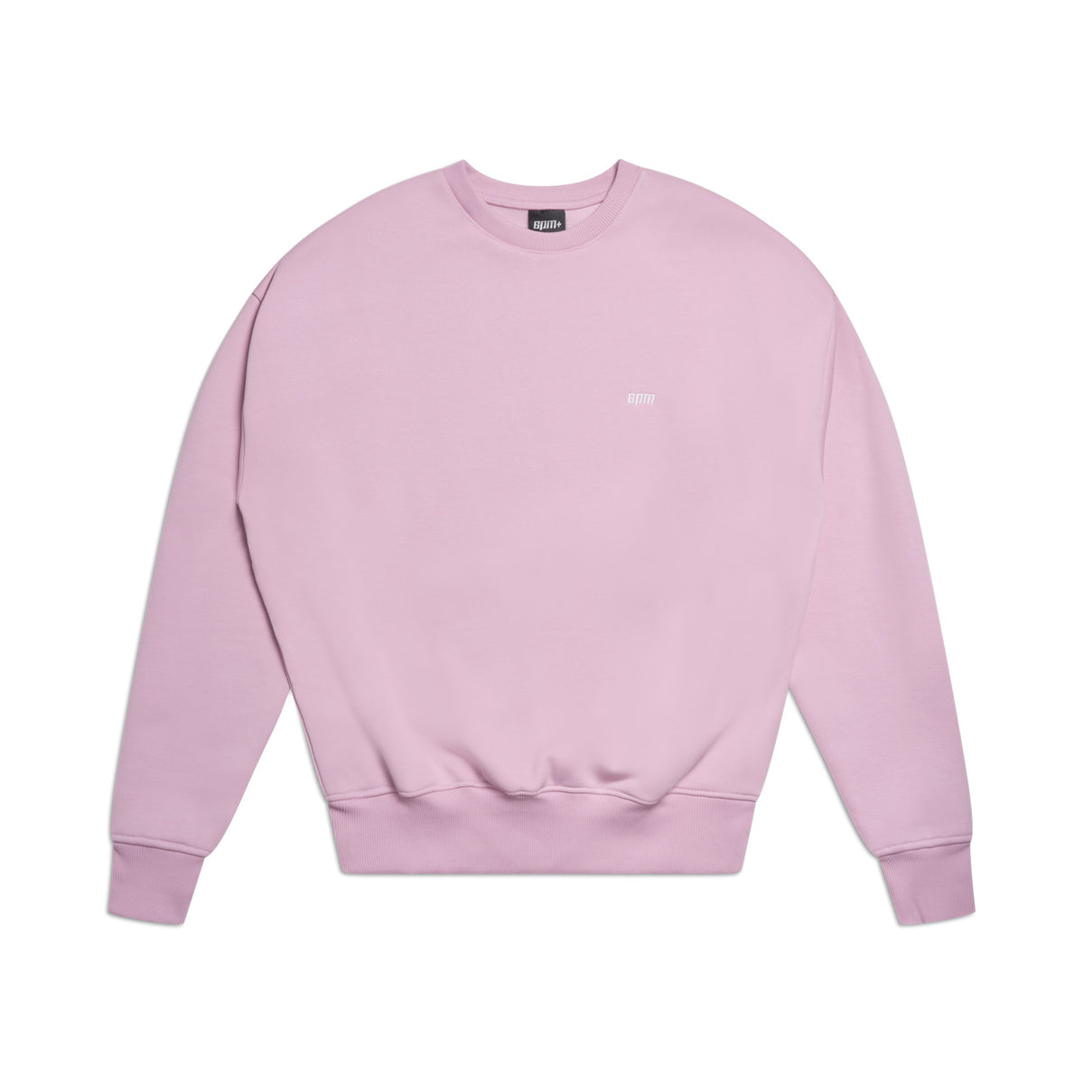 The 6PM CREWNECK BABY PINK is a plain, boxy fit sweatshirt in light pink with long sleeves, ribbed trims, and a small white logo on the upper chest, shown laid flat on a white background.