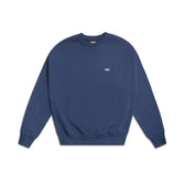 The 6PM CREWNECK NAVY is a plain navy blue sweatshirt with long sleeves, ribbed cuffs and hem, and a small white embroidered logo on the left chest, shown against a white background.