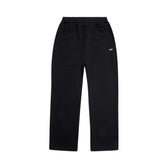 The OPEN LEG JOGGER BLACK features an elastic waistband, side pockets, stacking length, and a small white left-thigh logo—offering a modern classic style in black, shown on a plain white background.