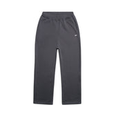 The 6PM OPEN LEG JOGGER ANTHRACITE is a modern classic straight-leg sweatpant in dark gray with an elastic waistband and two side pockets, designed for a stacking length look, shown laid flat on a white background.