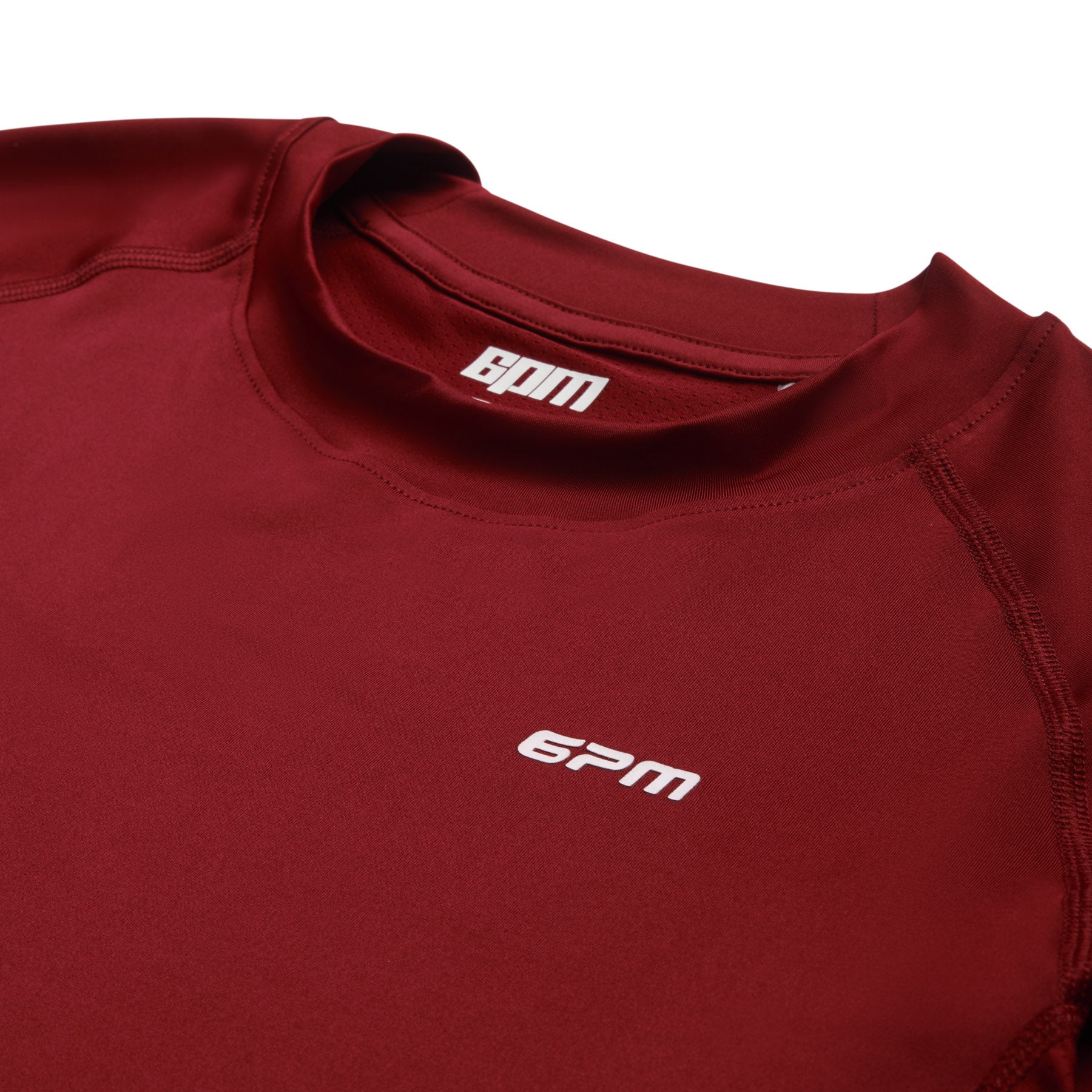 A close-up of the 6PM SPORTS LONGSLEEVE WINE RED shows the white 6PM logo on the chest and inner collar, with smooth fabric and visible seam stitching.