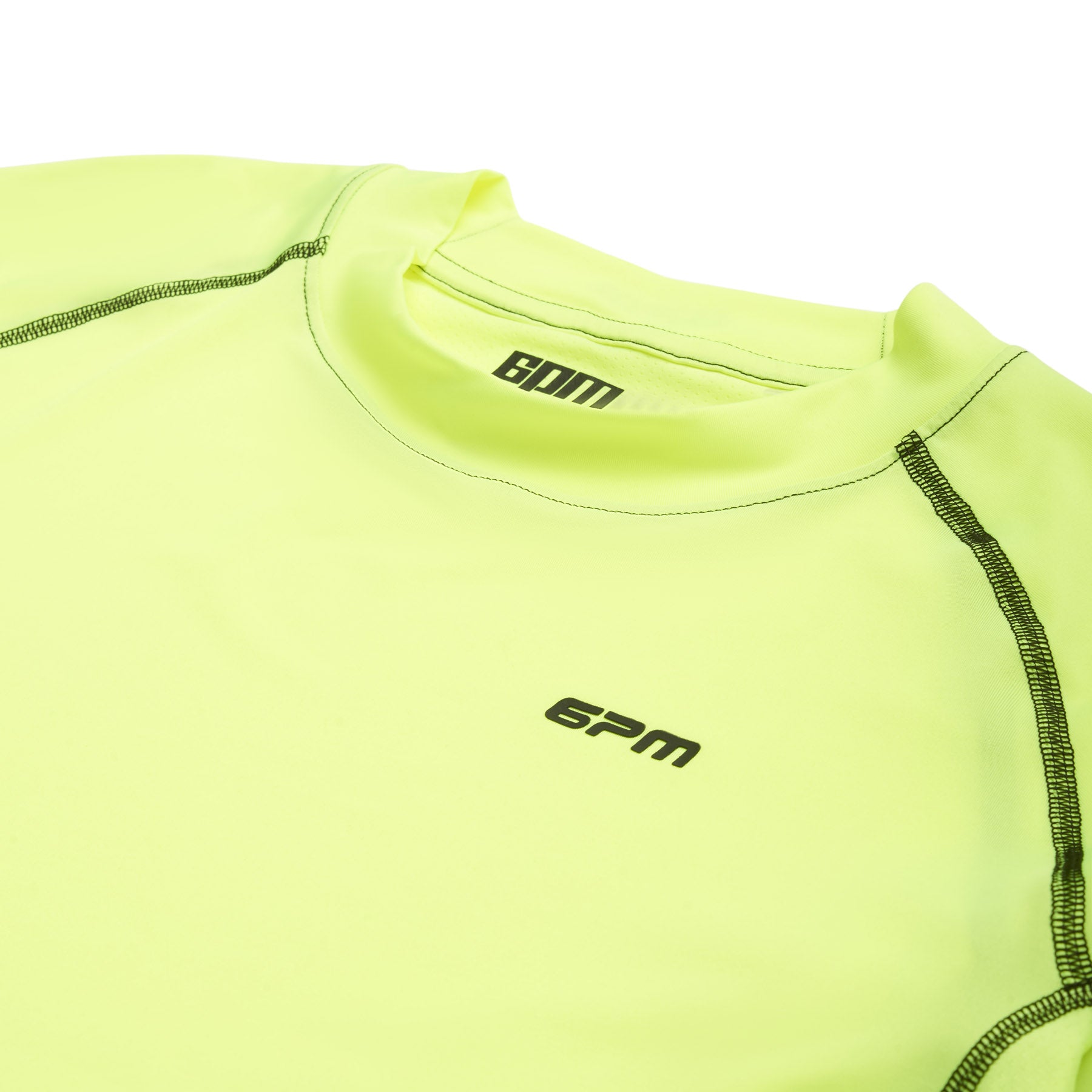 A close-up of the 6PM SPORTS LONGSLEEVE NEON YELLOW by 6PM, featuring neon yellow fabric, black stitching, and the 6PM logo in black on the chest and inside the collar.