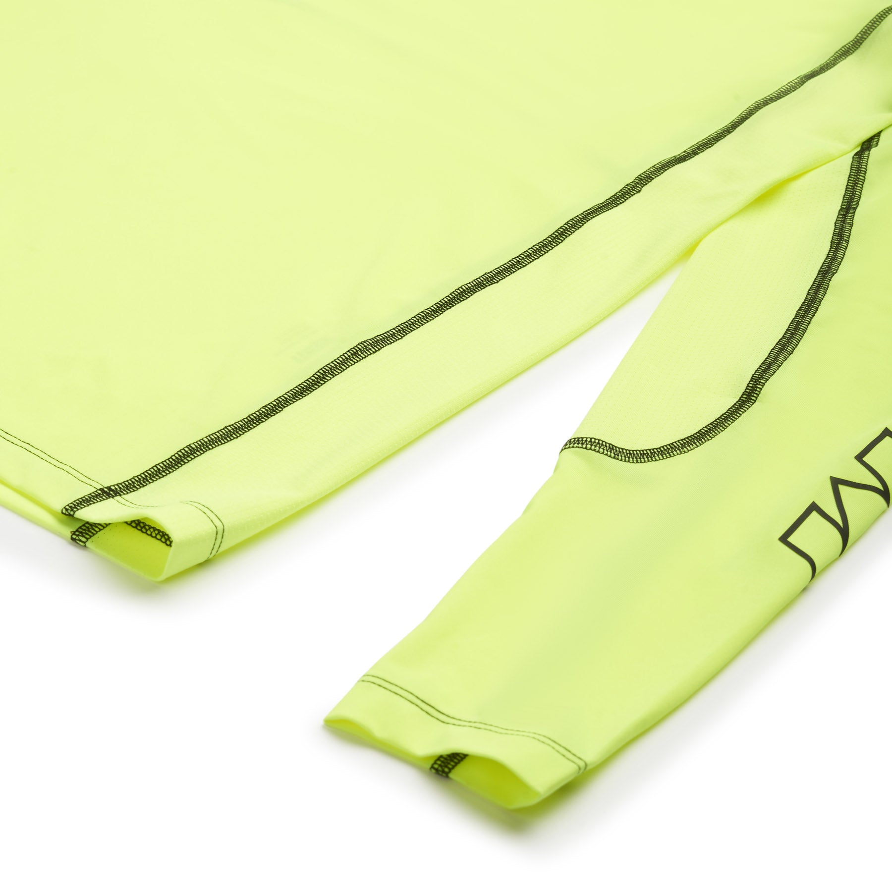 Close-up of the 6PM SPORTS LONGSLEEVE NEON YELLOW by 6PM, featuring neon yellow fabric, black stitching, and partial black text on the sleeve, shown against a white background.
