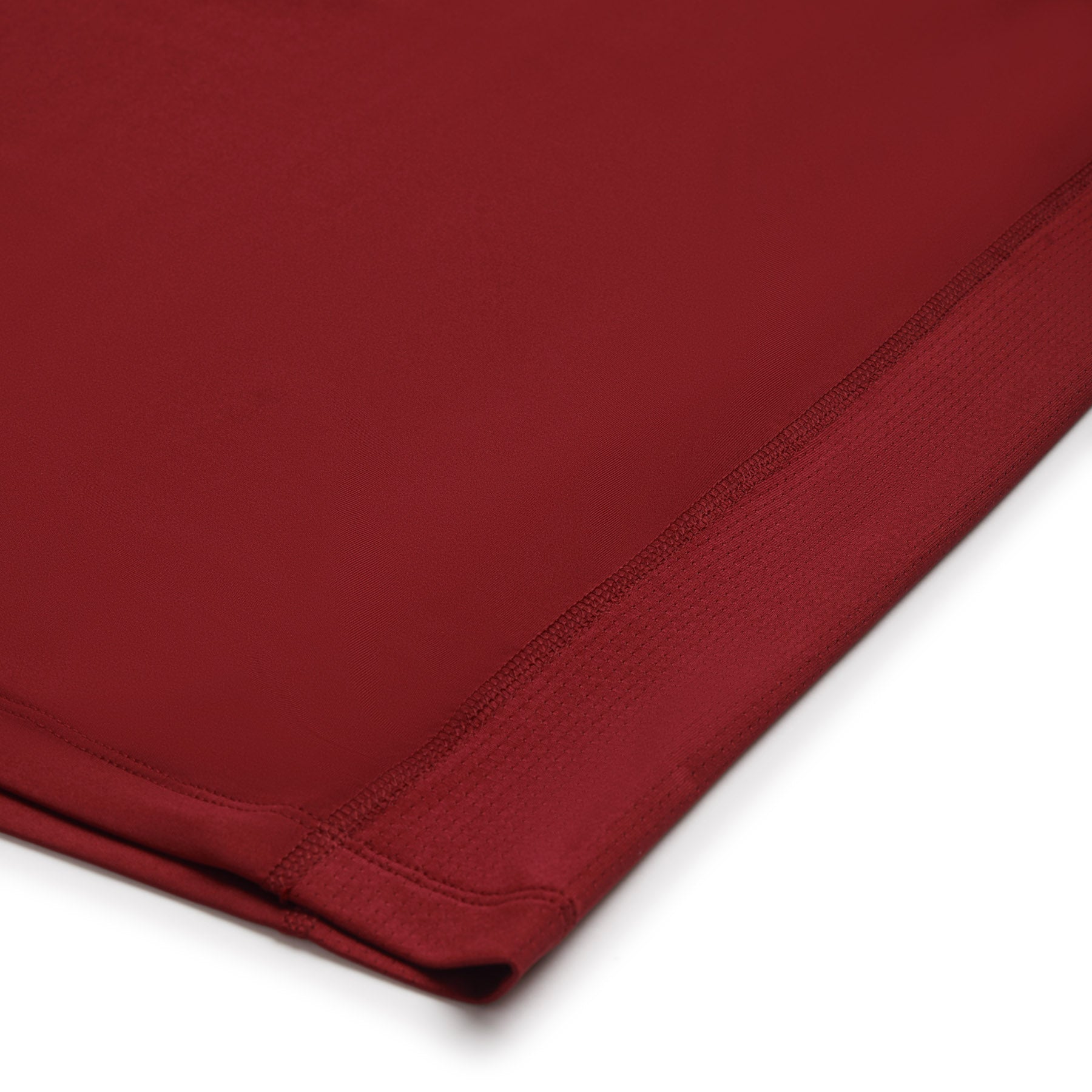 Close-up of the 6PM SPORTS T-SHIRT in wine red by 6PM, featuring stitched edges and a smooth, slightly textured fabric.