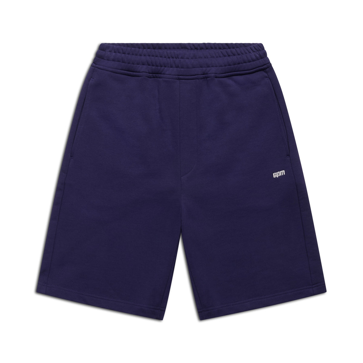 The 6PM+ SHORTS ORBIT BLUE by 6PM are dark blue athletic shorts featuring a relaxed fit, elastic waistband, side pockets, and a small white CDTM logo on the left thigh. Laid flat on a white background—perfect for lounging.