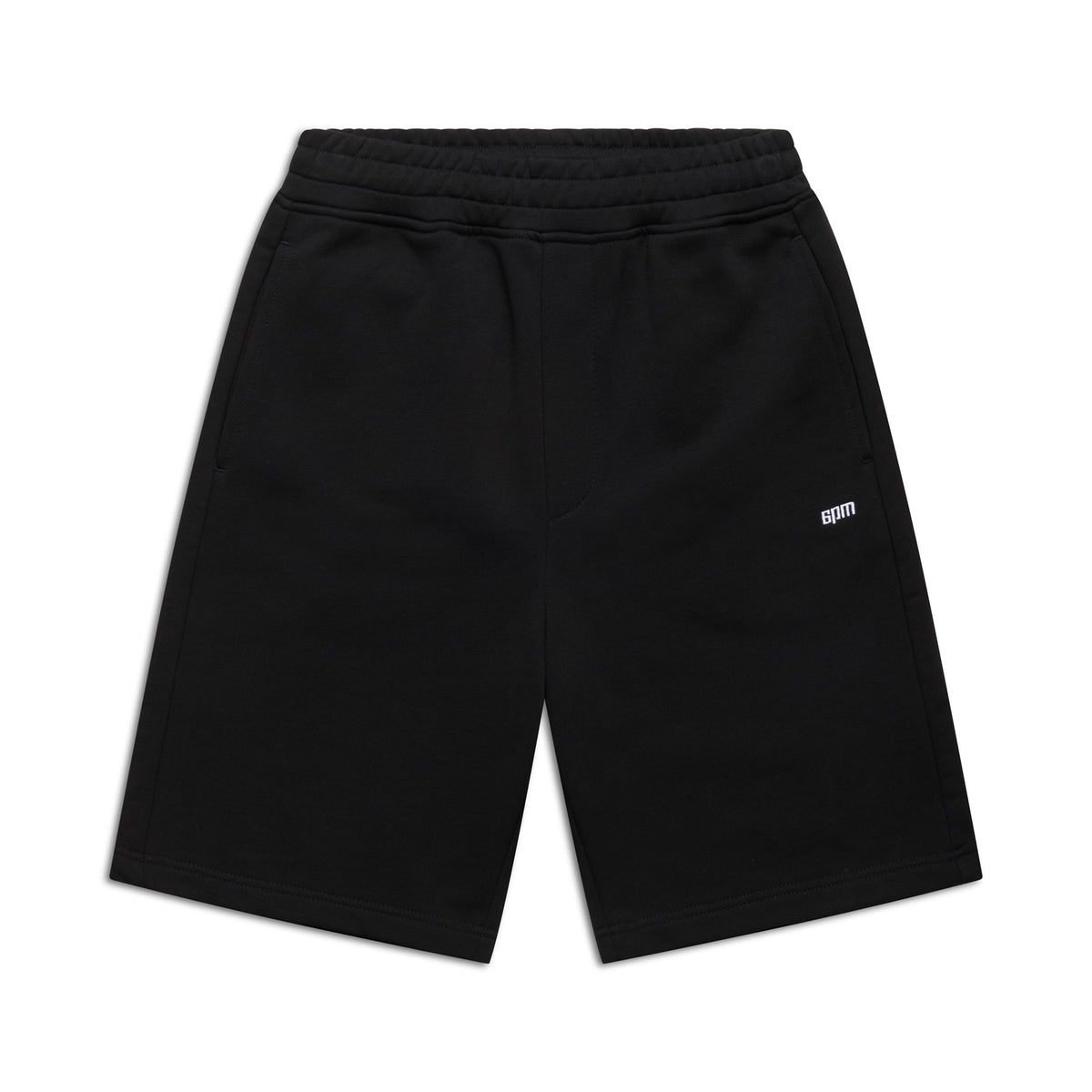 6PM+ SHORTS BLACK by 6PM: Relaxed-fit black athletic shorts with an elastic waistband, two side pockets, and a small white BOM logo on the left thigh. Perfect for lounging; shown laid flat on a white background.