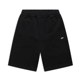 6PM+ SHORTS BLACK by 6PM: Relaxed-fit black athletic shorts with an elastic waistband, two side pockets, and a small white BOM logo on the left thigh. Perfect for lounging; shown laid flat on a white background.