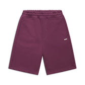 6PM+ SHORTS PLUM by 6PM are plum knee-length shorts with a relaxed fit, elastic waistband, side pockets, and a small white 6PM logo on the left thigh. They have a soft interior and are shown laid flat on a white background.