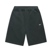 The 6PM+ SHORTS DARK EMERALD by 6PM are knee-length athletic shorts in dark emerald with a soft brushed interior, elastic waistband, side pockets, and a small white BDM logo on the left thigh, shown on a white background.