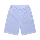 The 6PM+ SHORTS SOFT VIOLET are light blue athletic shorts featuring a relaxed fit, elastic waistband, two side pockets, and a small white logo on the left leg. Ideal for lounging, they’re shown laid flat on a white background.