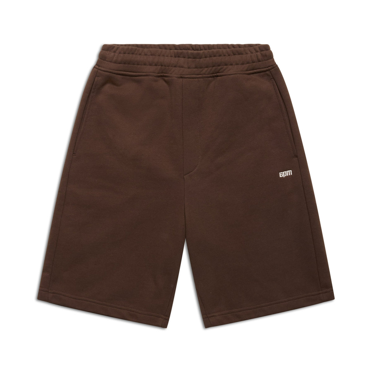 The 6PM+ Shorts Chocolate Brown by 6PM are knee-length, relaxed fit shorts featuring an elastic waistband, side pockets, and a small white GDM logo on the left thigh—perfect for lounging.