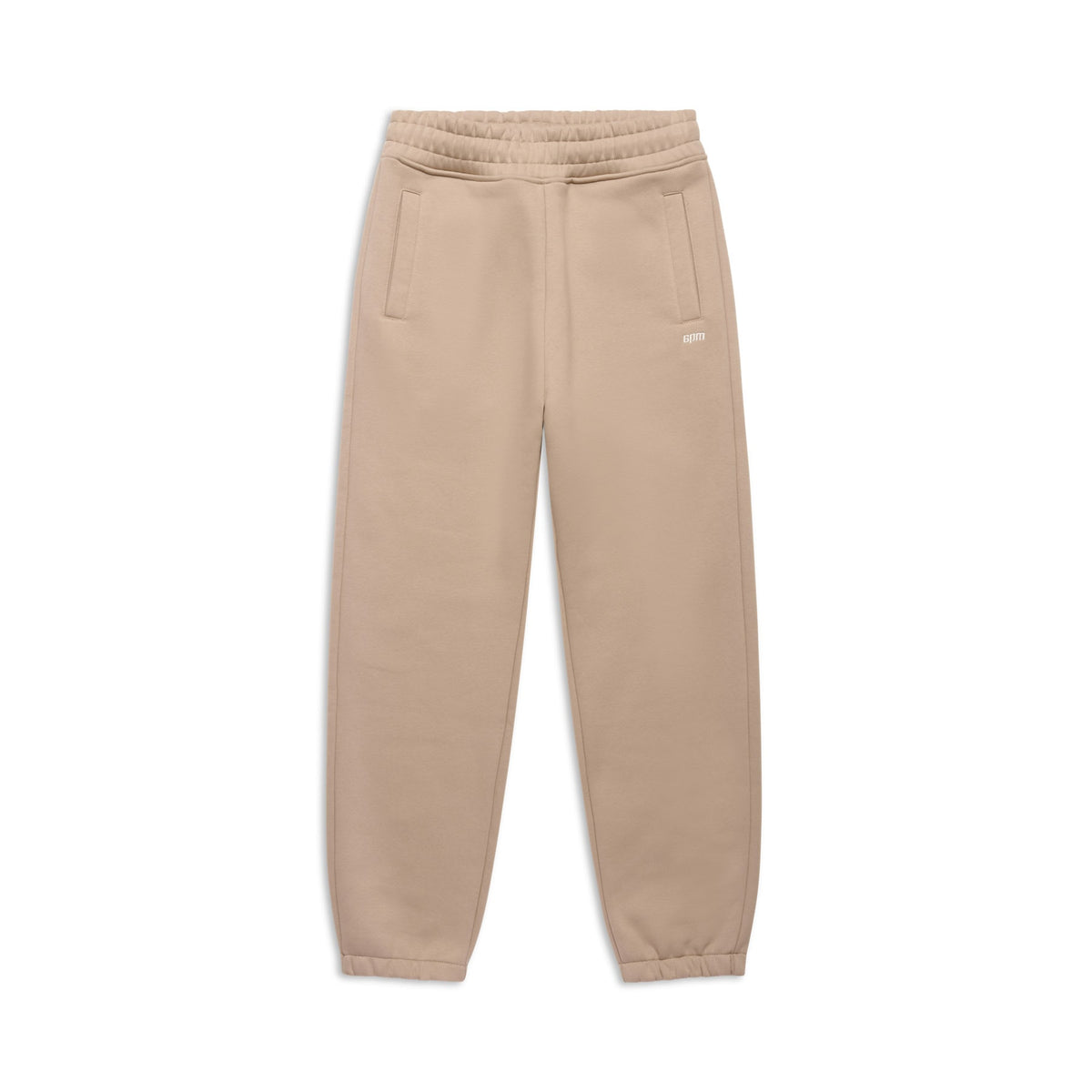 The CUFF JOGGER MOCCA CREAM by 6PM features an elastic waistband, cuffed leg openings, two side pockets, and a small white logo on the left hip, shown laid flat on a white background.