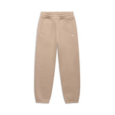 The CUFF JOGGER MOCCA CREAM by 6PM features an elastic waistband, cuffed leg openings, two side pockets, and a small white logo on the left hip, shown laid flat on a white background.