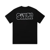 REFLECTIVE LOGO TEE BLACK by 6PM: Black tee featuring bold, graffiti-style reflective SIXPM text on the back, displayed against a plain white background.