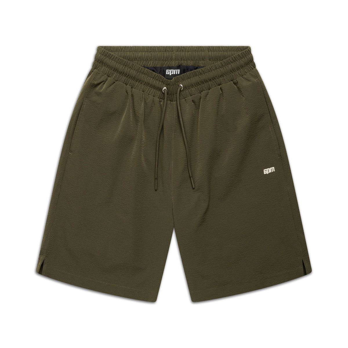 6PM SEERSUCKER SWIM SHORTS in olive feature an elastic waistband, drawstring, side pockets, and a small white BPM logo on the left leg, shown on a white background.