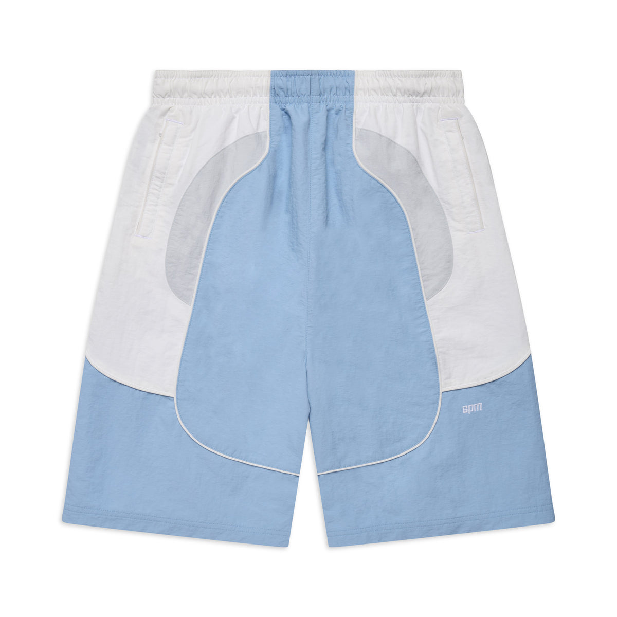 The BAGGY WARM UP SHORTS ICE BLUE by 6PM feature light blue and white color blocking, an elastic waistband, side pockets, and a small CPFM logo on the lower left leg. The shorts are shown laid flat on a white background.