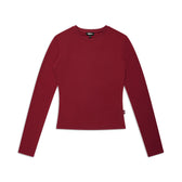 The 6PM WMNS LONGSLEEVE WINE RED is a fitted, long-sleeve shirt with a crew neckline, shown laid flat on a white background. It features a solid wine red color with no visible patterns or designs.