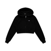 The 6PM WMNS CROPPED ZIP HOODIE BLACK features long sleeves, front pockets, a hood, and a small white logo on the left chest, shown on a white background.