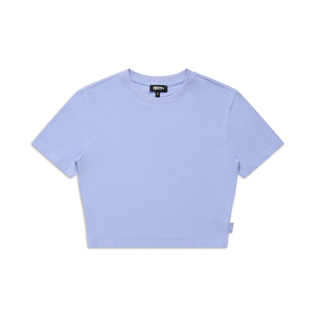 The 6PM WMNS CROPPED T-SHIRT SOFT VIOLET is a plain, light purple, short-sleeved crop top with a round neckline and a small fabric tag on the lower left, shown laid flat on a white background.