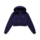 The 6PM WMNS CROPPED ZIP HOODIE ORBIT BLUE is a dark navy zip-up hoodie with long sleeves, a hood, and a small white logo on the left chest, shown laid flat on a white background.