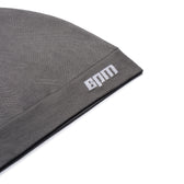 A close-up of the TECHNICAL LOGO BEANIE ANTHRACITE by 6PM, featuring BAM embroidered in white on the cuff, displayed against a white background.