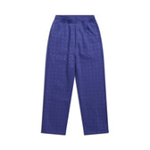 The 6PM RHINESTONE OPEN LEG JOGGER BLUE is a high-waisted, straight-leg pant in blue with a subtle grid of small white dots, shown laid flat on a white background.