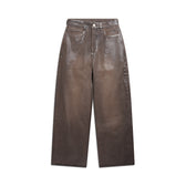 The WAX COATED DENIM BROWN pants from 6PM feature a high-waisted, wide-leg design with front pockets, belt loops, and a button-zipper closure, shown flat on a white background.