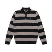 The 6PM LS STRIPED POLO BLACK features wide black and gray stripes, a black collar, three-button neck, and a small white logo on the left chest.