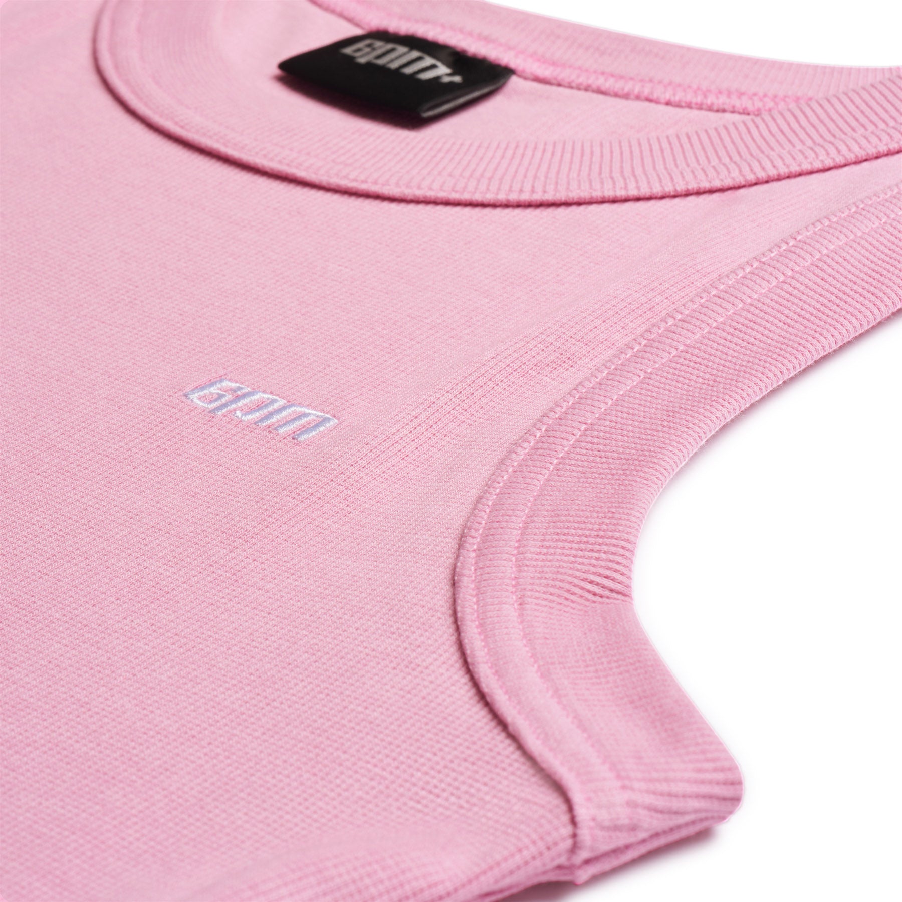 Close-up of the TANK TOP PINK by 6PM, a sleeveless ribbed top with a round neckline. 6PM is embroidered in small white letters on the chest, and a black 6PM label is visible inside the collar.