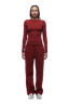 A person with braided hair faces forward, wearing the 6PM WMNS LONGSLEEVE WINE RED top and matching bottoms with white sneakers against a white background.