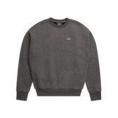 The 6PM CREWNECK DARK GREY MELANGE is a boxy fit sweatshirt with long sleeves, ribbed trims, and a small white logo on the upper left chest. It is shown laid flat on a white background.