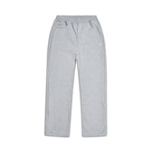 The 6PM OPEN LEG JOGGER GREY features a light gray color, elastic waistband with drawstrings, and side pockets, shown laid flat on a white background for a modern classic look.